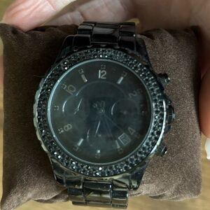Michael Kors black metal watch w black rhinestones around watch face.